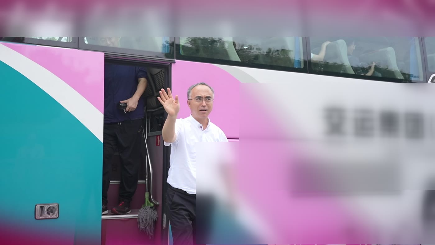 参会者在大巴车前集结登车